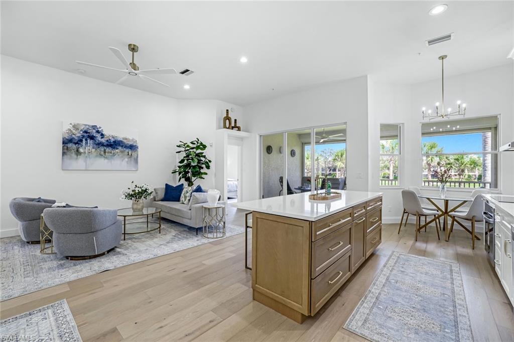 630 Lalique Circle, Unit 506 Naples, FL 34119 - Photo 7 of 25 a living room with furniture and a chandelier