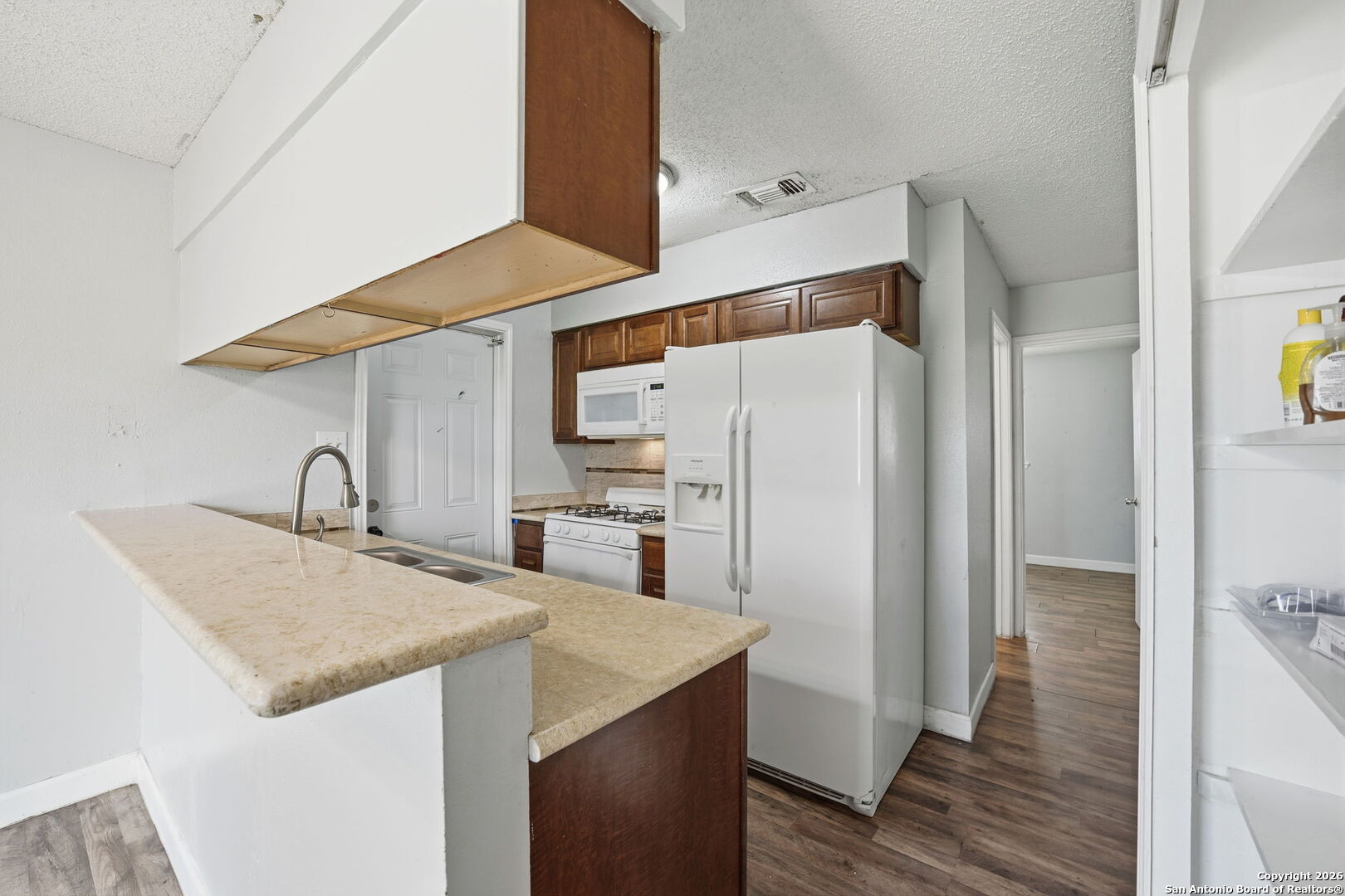 126 Meadow Way Converse, TX 78109 - Photo 12 of 33 a kitchen with stainless steel appliances a refrigerator and a stove