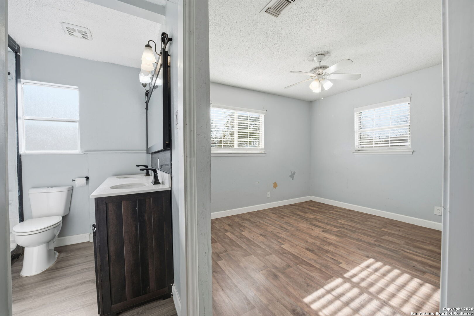 126 Meadow Way Converse, TX 78109 - Photo 18 of 33 a view of bathroom with a toilet sink a mirror and vanity