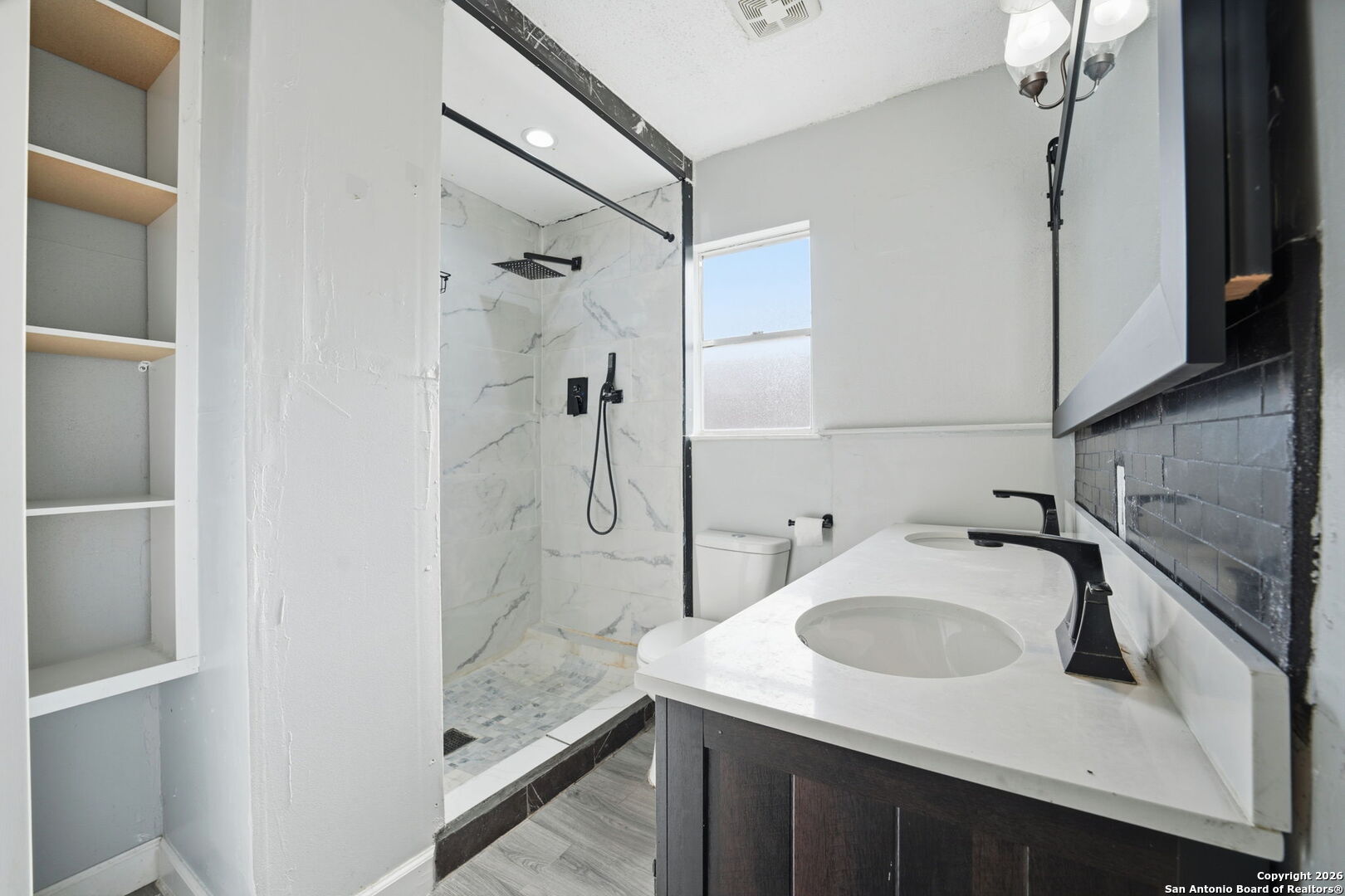 126 Meadow Way Converse, TX 78109 - Photo 19 of 33 a bathroom with a sink and a mirror