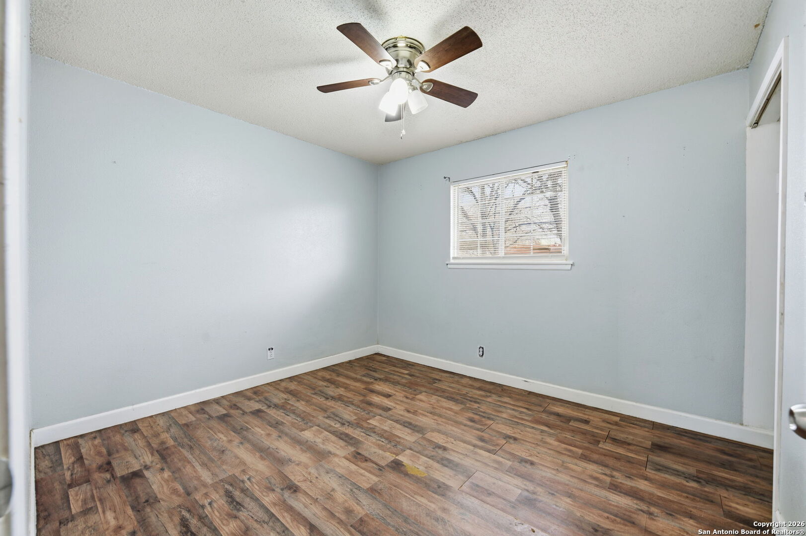 126 Meadow Way Converse, TX 78109 - Photo 21 of 33 an empty room with a window and a ceiling fan