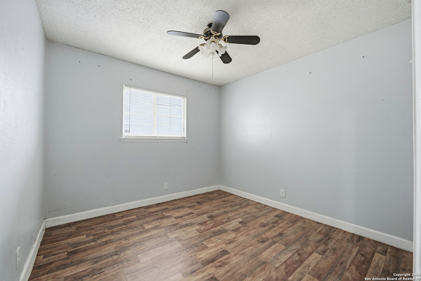 126 Meadow Way Converse, TX 78109 - Photo 25 of 33 wooden floor in an empty room with a window