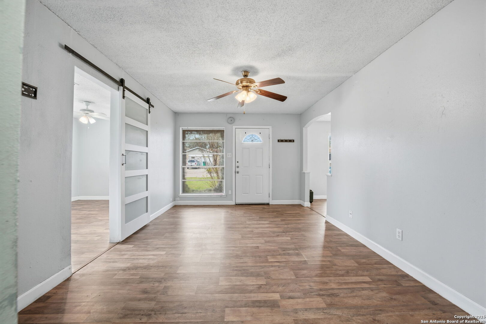 126 Meadow Way Converse, TX 78109 - Photo 5 of 33 wooden floor in an empty room with a window