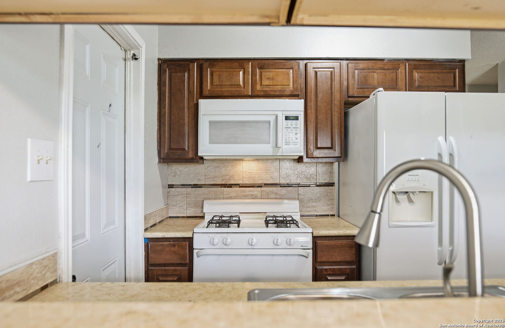 126 Meadow Way Converse, TX 78109 - Photo 10 of 33 a kitchen with a stove and a microwave