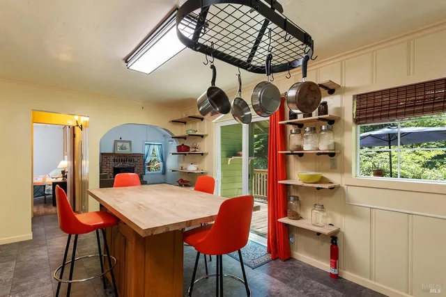 a dining room with furniture and a window