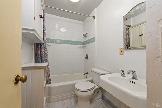 a en suite bathroom with a toilet a sink and a shower