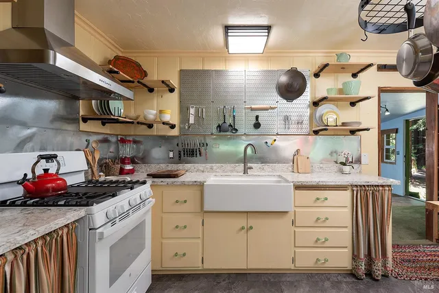 a kitchen with stainless steel appliances granite countertop a sink and a stove