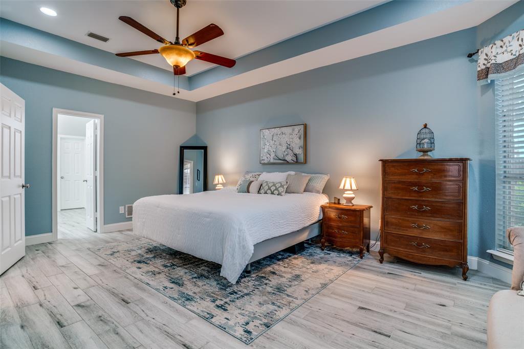 411 Wolverley Lane Allen, TX 75002 - Photo 16 of 27 a bedroom with a bed and a ceiling fan