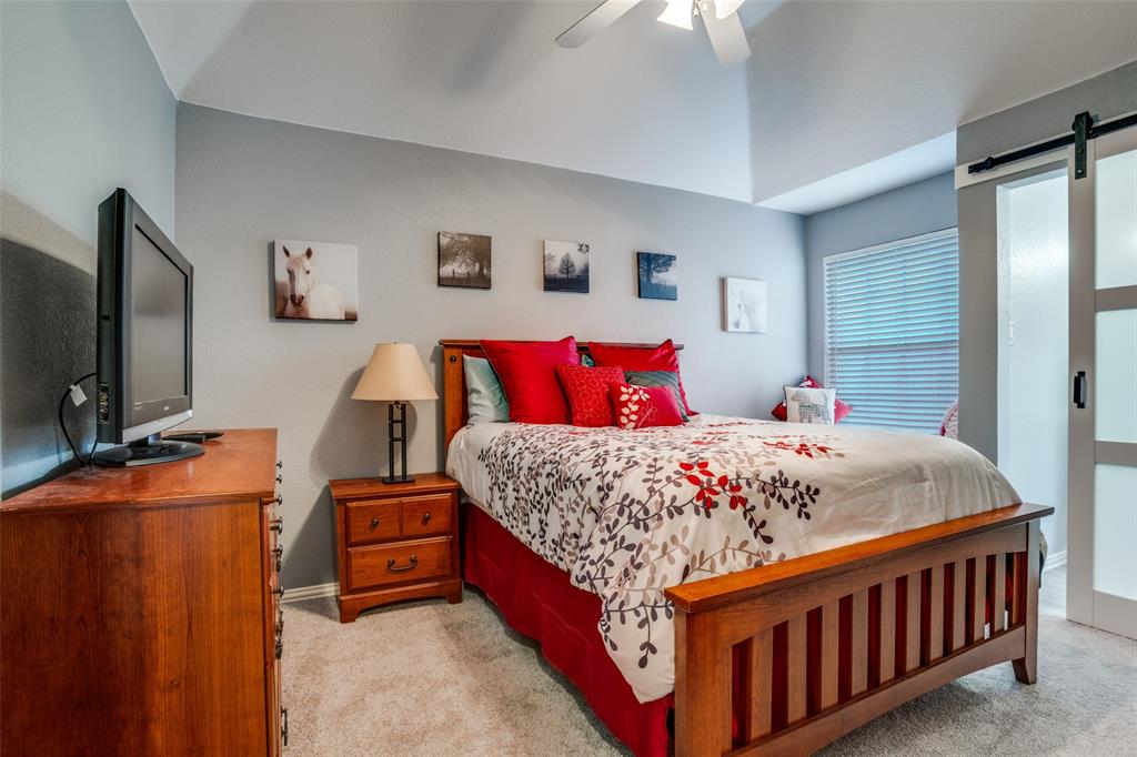 411 Wolverley Lane Allen, TX 75002 - Photo 19 of 27 a bedroom with a bed window and a flat screen tv