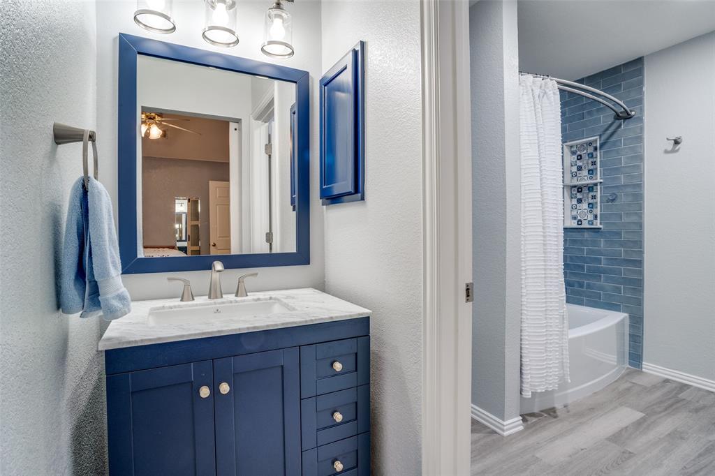 411 Wolverley Lane Allen, TX 75002 - Photo 20 of 27 a bathroom with a sink a toilet and shower