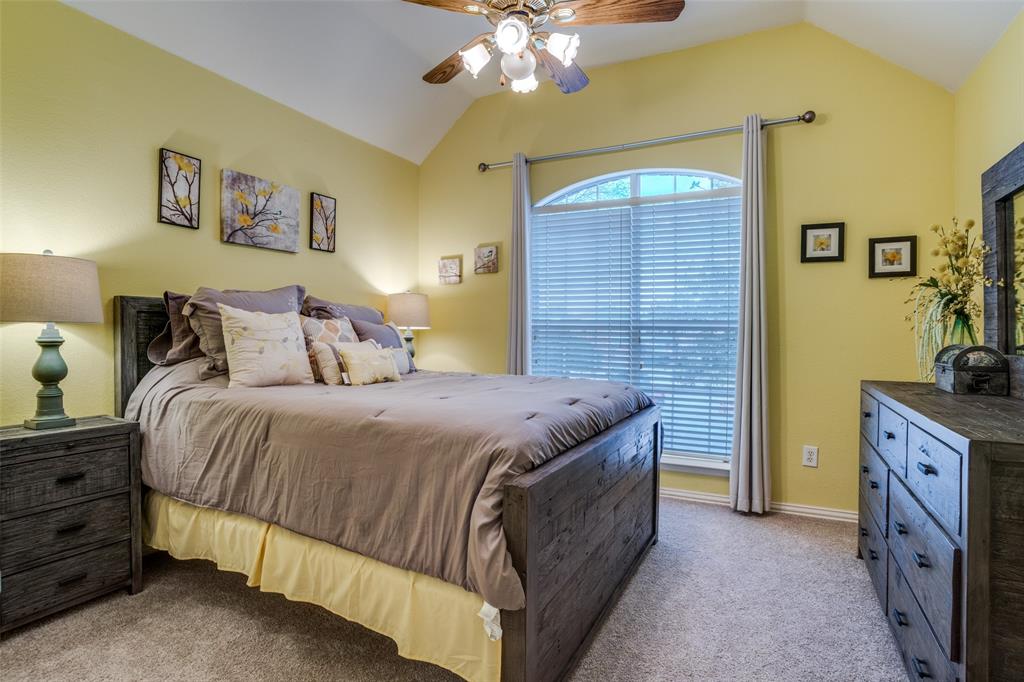 411 Wolverley Lane Allen, TX 75002 - Photo 21 of 27 a bedroom with a bed and a chandelier