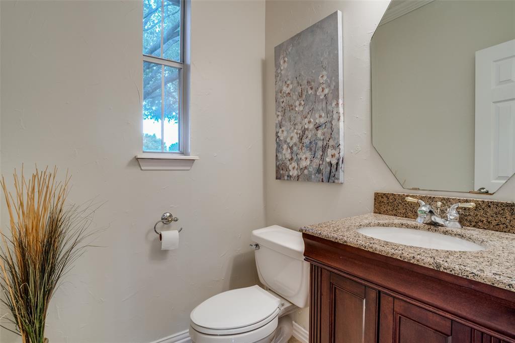 411 Wolverley Lane Allen, TX 75002 - Photo 23 of 27 a bathroom with a granite countertop toilet sink and mirror