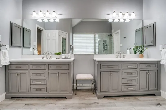 a bathroom with a double vanity sink and a mirror
