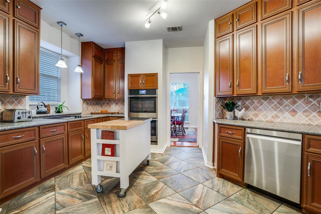 411 Wolverley Lane Allen, TX 75002 - Photo 10 of 27 a kitchen with stainless steel appliances granite countertop a stove a sink and a refrigerator