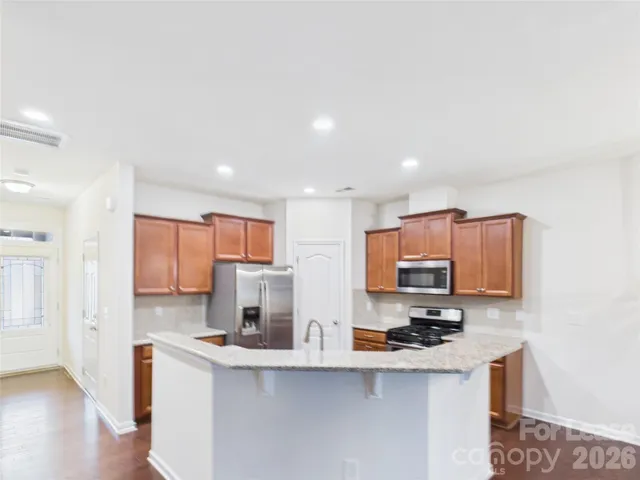 a kitchen with stainless steel appliances a sink stove top oven and cabinets