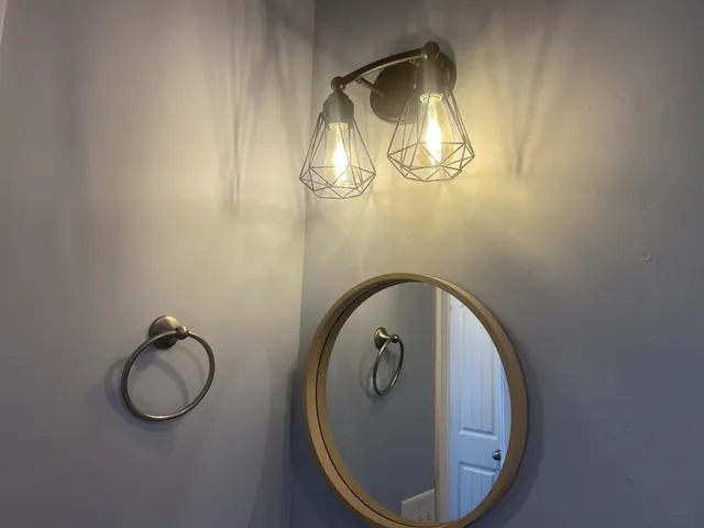 a bathroom with mirror and a toilet