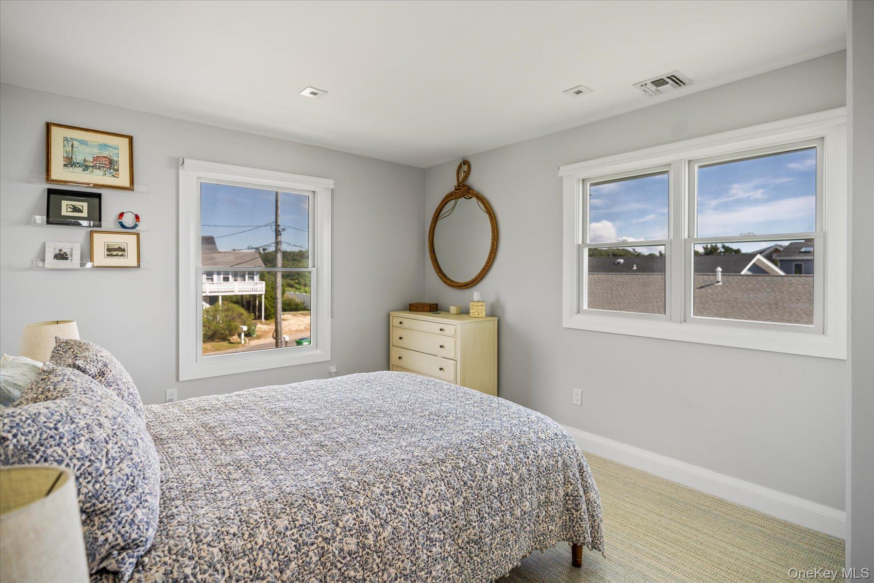 4415 Camp Mineola Road Mattituck, NY 11952 - Photo 19 of 44 a bedroom with a bed and a window