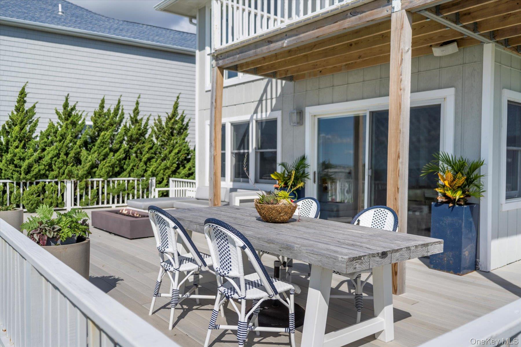 4415 Camp Mineola Road Mattituck, NY 11952 - Photo 30 of 44 a outdoor dining space with furniture and wooden floor