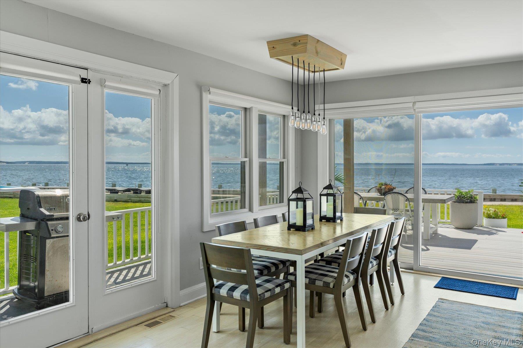 4415 Camp Mineola Road Mattituck, NY 11952 - Photo 10 of 44 Dining space seamlessly connected to kitchen and living room with panoramic water views.