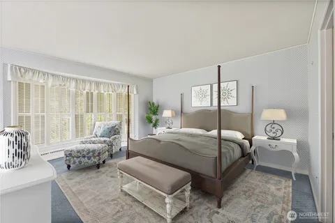 a bedroom with a bed and large window