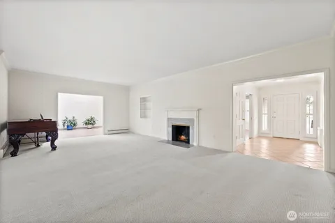a view of a livingroom with an empty space and a fireplace