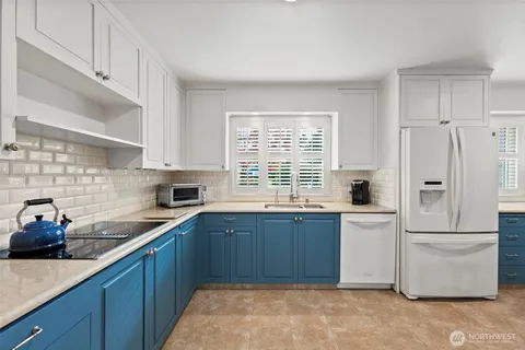 a kitchen with a sink stove and refrigerator