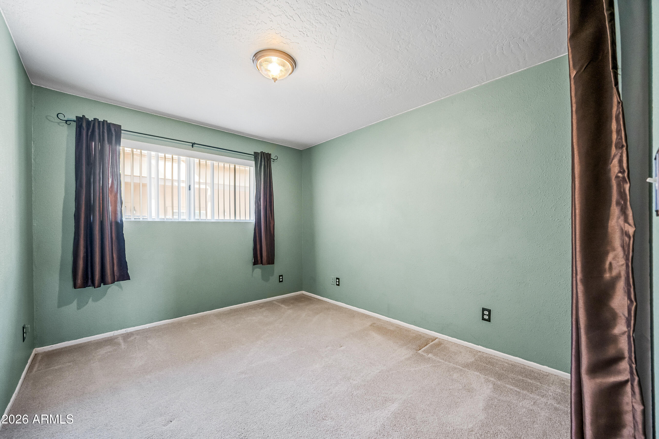 322 East Redfield Road Chandler, AZ 85225 - Photo 26 of 50 a view of an empty room with wooden floor and a window
