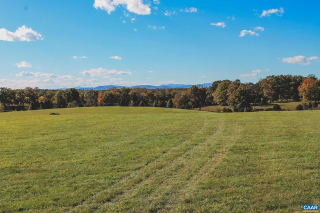 a view of a lake with houses in the background