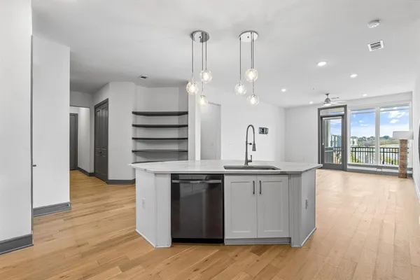 a kitchen with stainless steel appliances kitchen island granite countertop a stove a refrigerator and a stove top oven