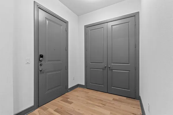a view of a room with furniture and wooden floor