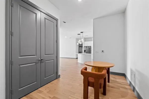 a view of a hallway with wooden floor and furniture