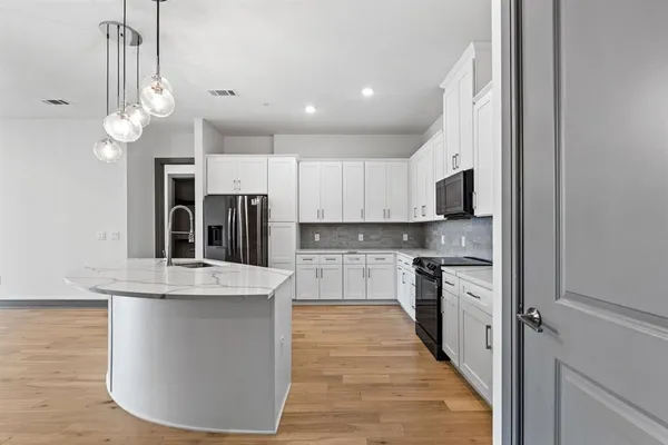 a kitchen with stainless steel appliances a refrigerator sink and cabinets