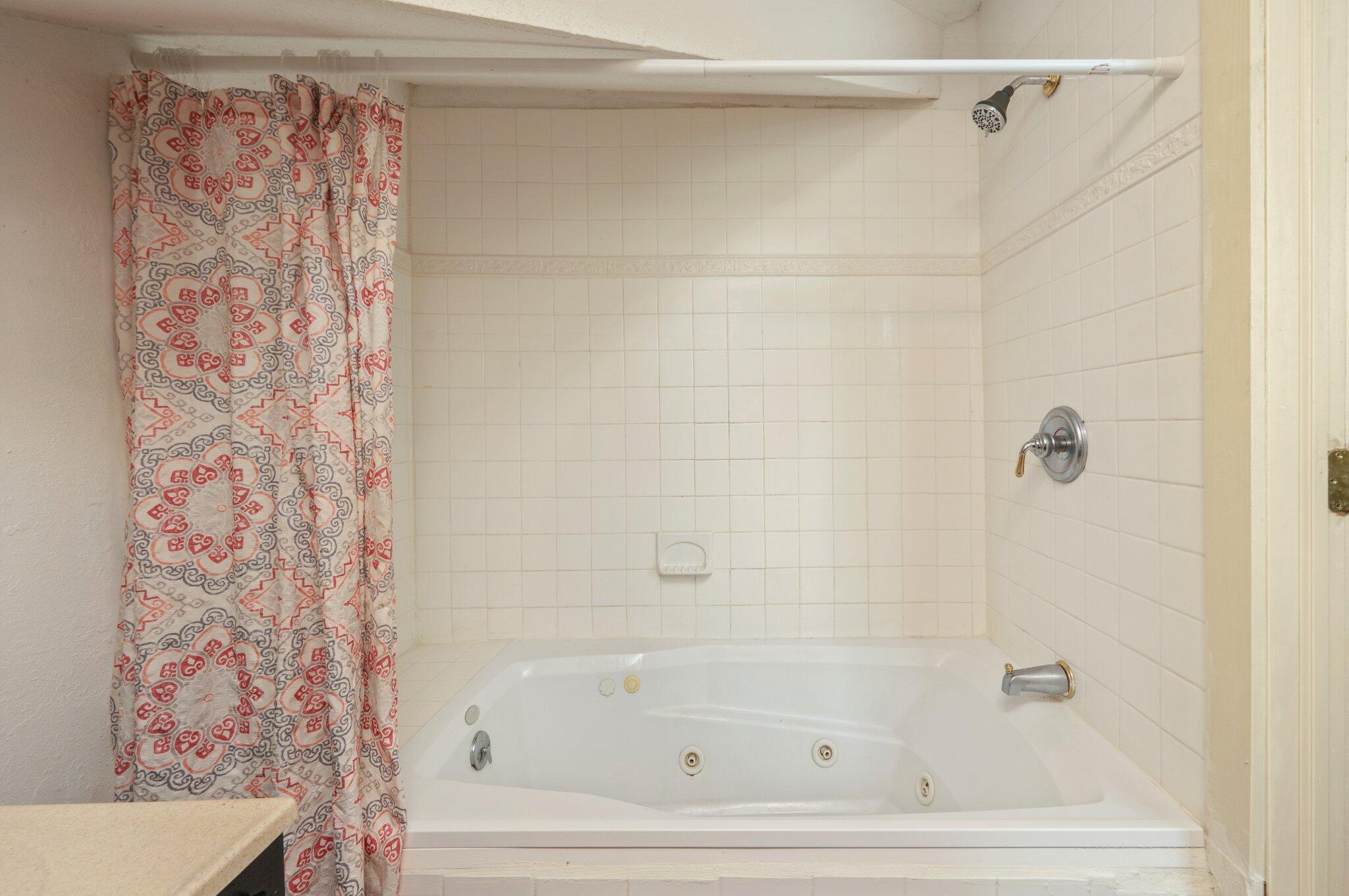 938 5th Street Florala, AL 36442 - Photo 42 of 65 a bathroom with a bathtub and shower