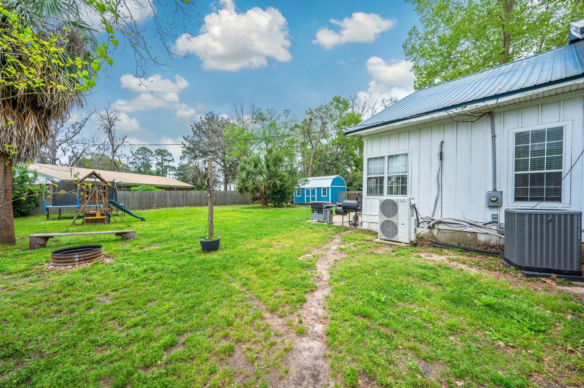 938 5th Street Florala, AL 36442 - Photo 53 of 65 a view of a chair and table in backyard of the house