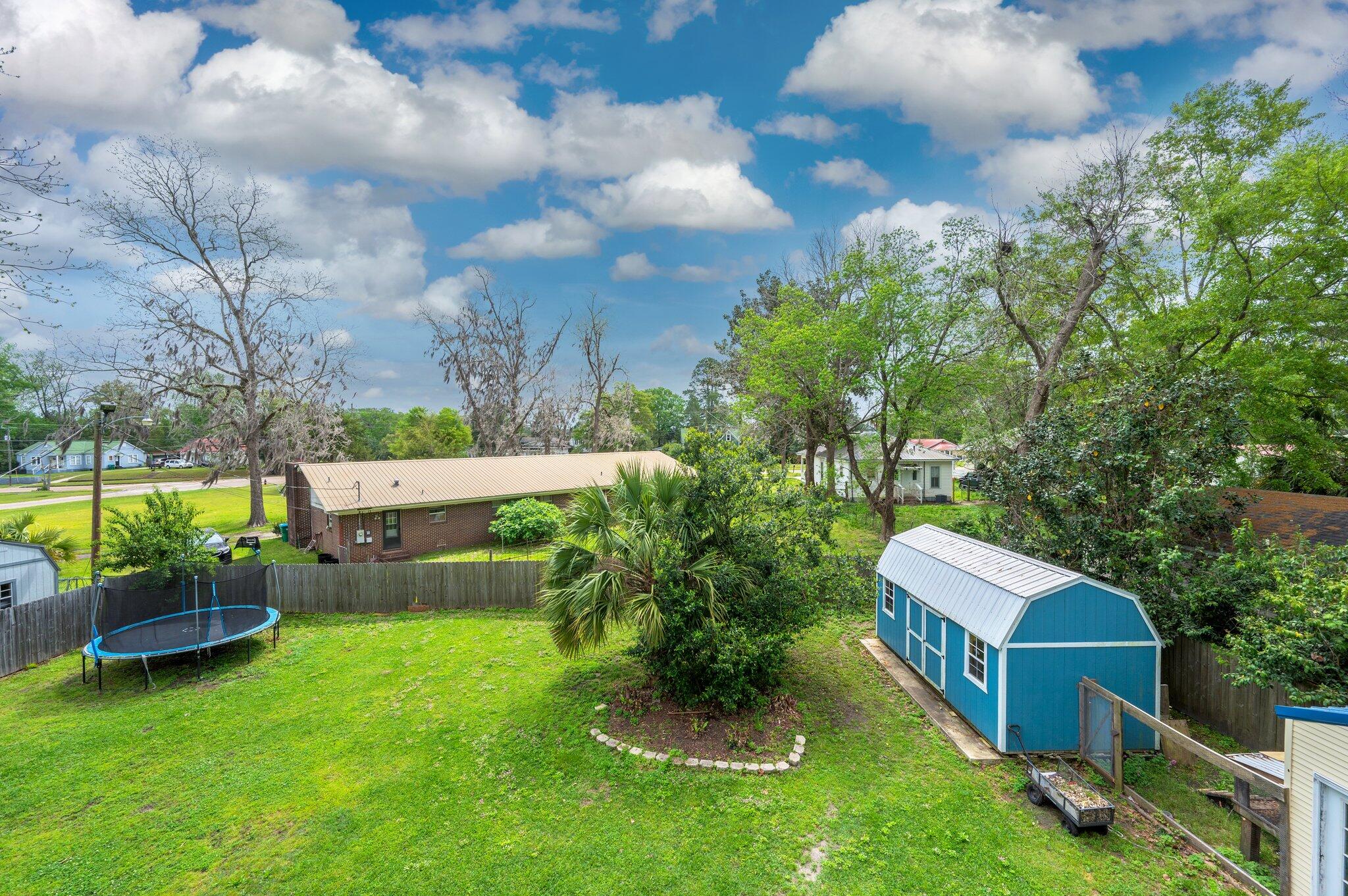 938 5th Street Florala, AL 36442 - Photo 56 of 65 a backyard of a house with table and chairs