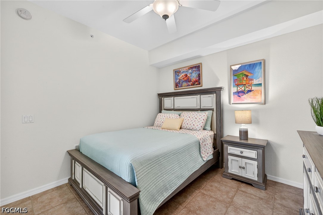 8251 Pathfinder Loop, Unit 621 Fort Myers, FL 33919 - Photo 16 of 30 a bedroom with a bed and a chandelier