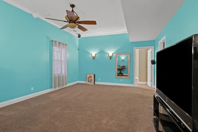 an empty room with a chandelier fan