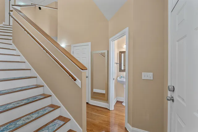 a view of entryway and gallery with wooden floor