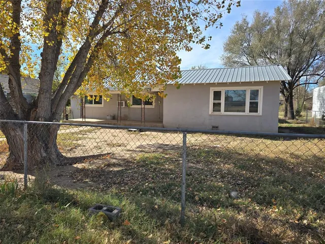 a front view of house with yard and trees