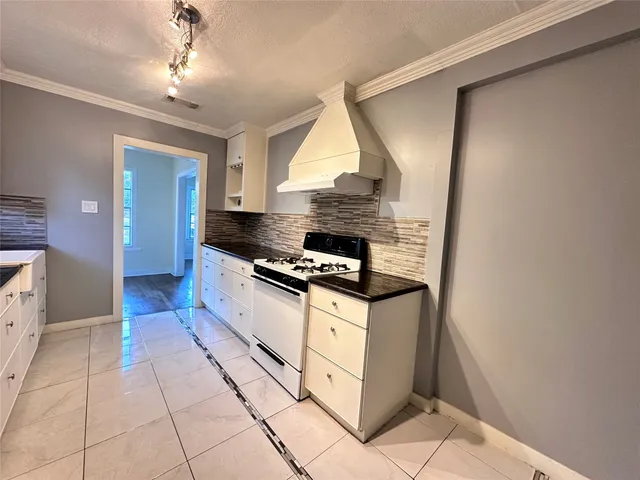 a kitchen with stainless steel appliances granite countertop a stove and a refrigerator