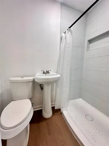 a white toilet sitting next to a bathroom sink