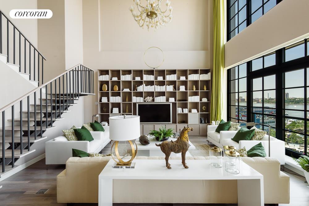 200 11th Avenue, Unit 9S Manhattan, NY 10011 - Photo 1 of 1 a living room with furniture and a large window