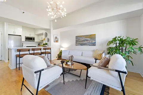 a kitchen with stainless steel appliances granite countertop white cabinets a sink a stove and a microwave