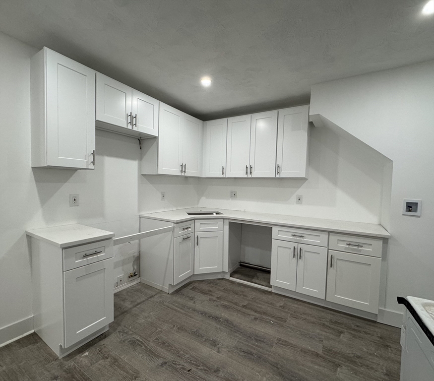 120 Sea Street, Unit A Barnstable, MA 02601 - Photo 1 of 6 a kitchen with a sink cabinets and wooden floor