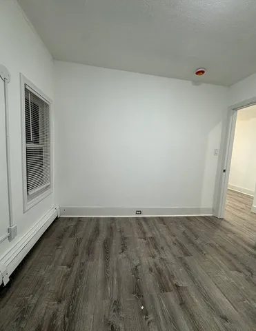 a view of an empty room and wooden floor