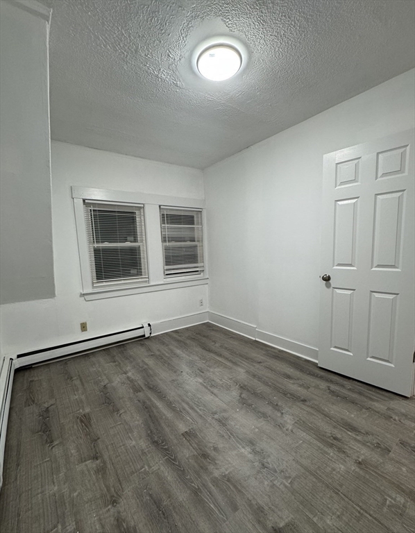 120 Sea Street, Unit A Barnstable, MA 02601 - Photo 4 of 6 an empty room with wooden floor and windows