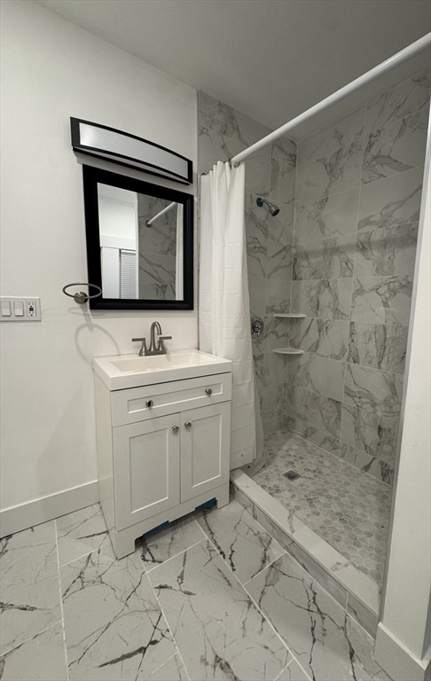 120 Sea Street, Unit A Barnstable, MA 02601 - Photo 5 of 6 a bathroom with a sink mirror and a shower