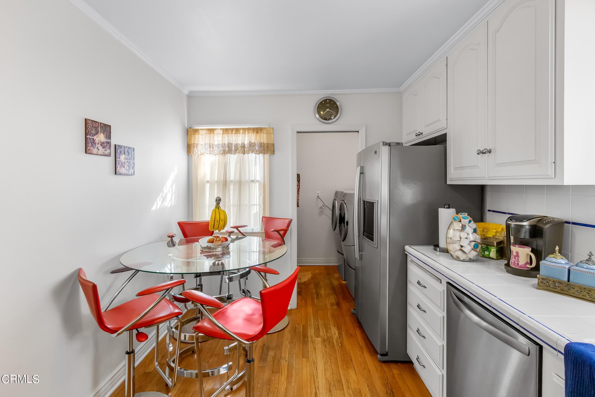 432 West Poppyfields Drive Altadena, CA 91001 - Photo 6 of 23 a kitchen with stainless steel appliances granite countertop a refrigerator a sink dishwasher and white cabinets with wooden floor