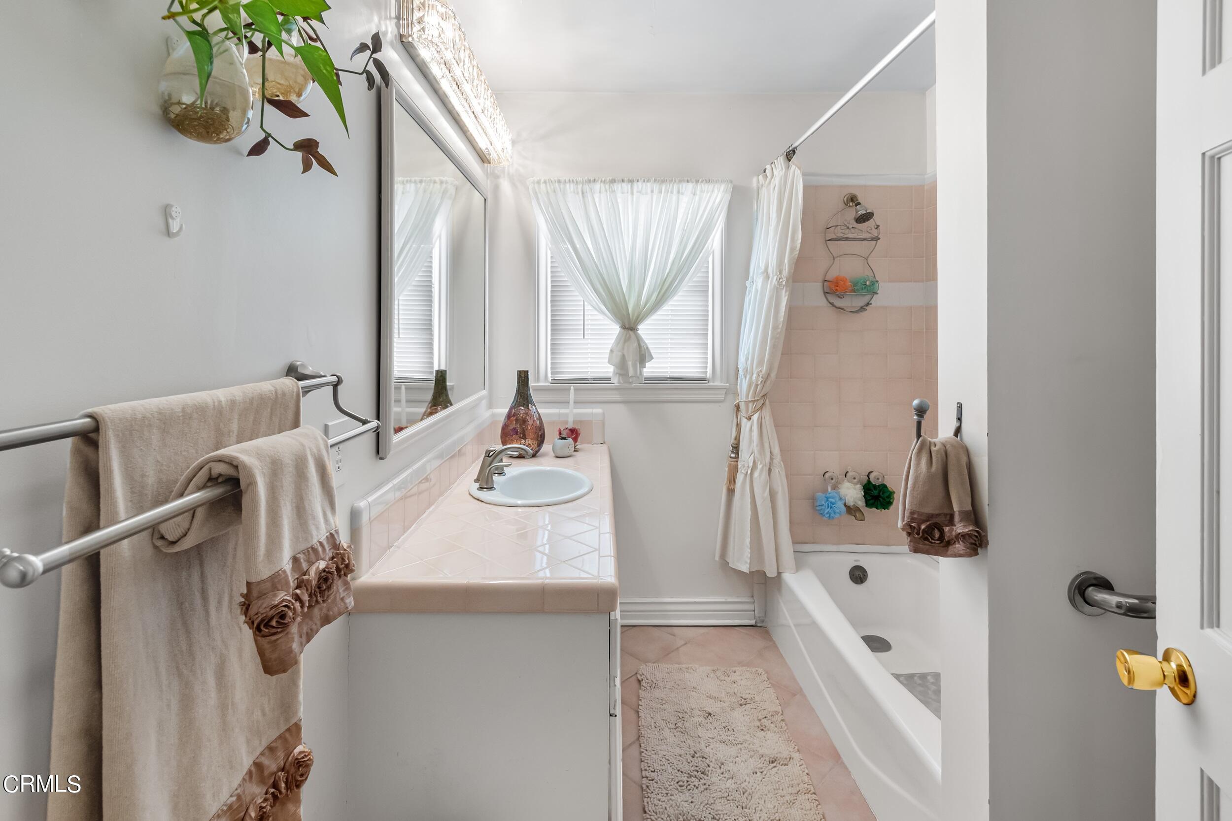 432 West Poppyfields Drive Altadena, CA 91001 - Photo 10 of 23 a bathroom with a tub sink and mirror