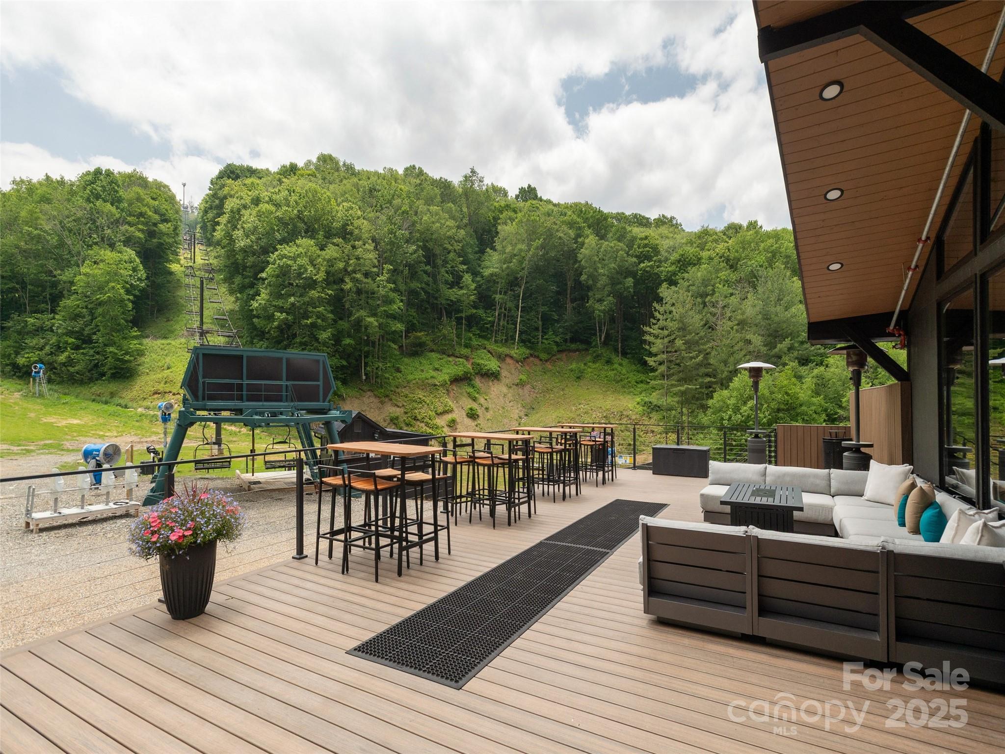 0 English Ridge Drive, Unit 34 Mars Hill, NC 28754 - Photo 27 of 32 a view of a roof deck with table and chairs couches with wooden floor